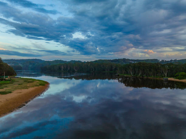 istock Sunrise reflections and clouds at the seaside with lagoon 1387907428