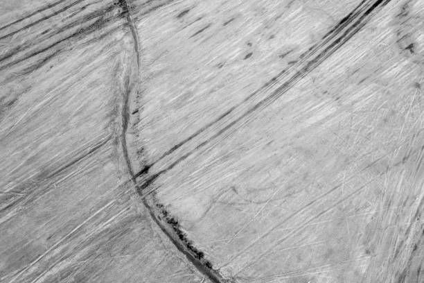 istock Vehicle Tyre Tracks Form Abstract Pattern Overhead Salt Flats 1387908847