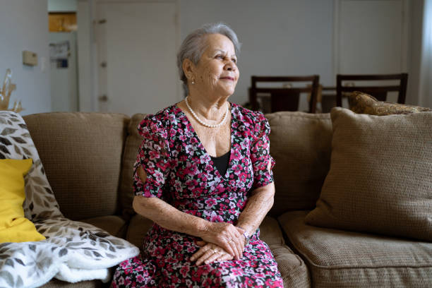 istock Confident senior woman at home looking away 1387909086