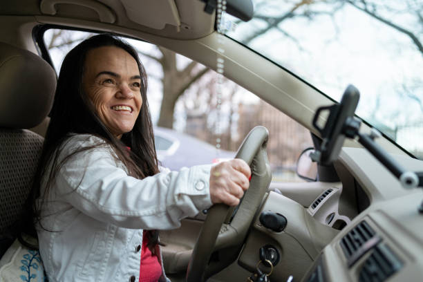 Confident latin woman with dwarfism driving stock photo