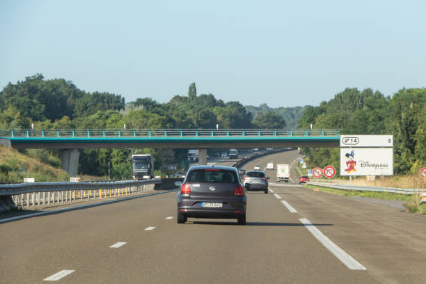 Coutevroult – France, August 19, 2019 : Cars on the highway near Disneyland roadsign