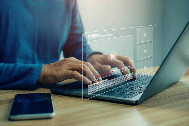 istock Businessman hands using laptop for streaming online 1387913663