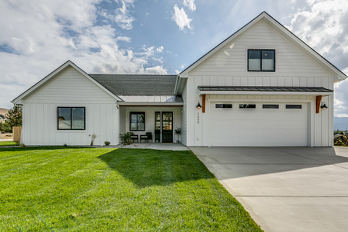 Front exterior of a large greyish blue new home in Virginia.