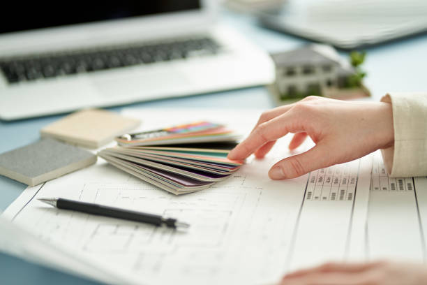 istock Asian female architect designing a house 1387919122