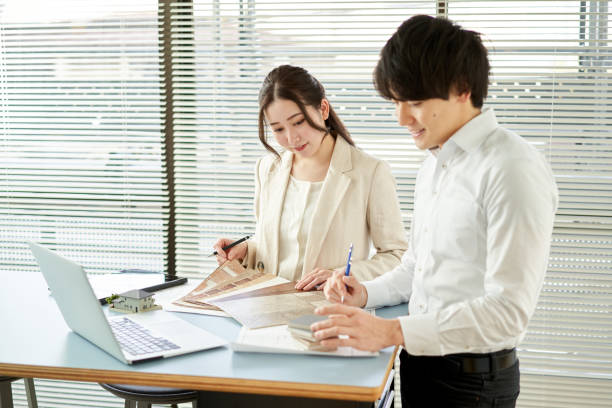 istock Asian architect designing a house 1387919147