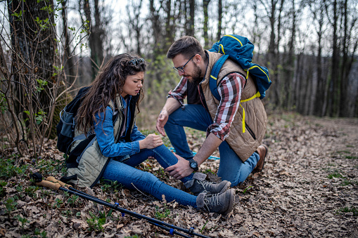 A woman has sprained her knee while hiking