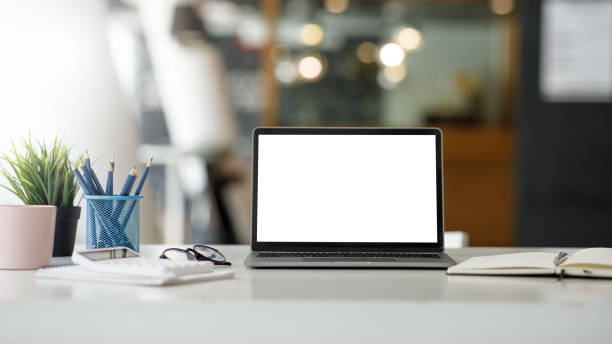 istock workspace,Wooden desk and computer in the office working space with mock-up laptop computer devices, workspace concept. 1387923982