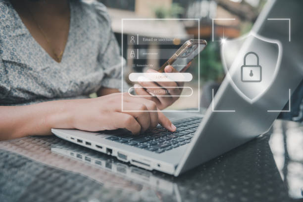 istock Personal Data Access and Technology Security for Business Financial. Business Woman Using Mobile While Accessing Private Data on Laptop. Technology Database Security Network System for Global Business 1387927006