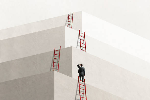 Man Looks Up At Series of Ladders Leading To Successively Higher Levels A man looks up at a series of ladders that lead him to the next level, eventually reaching the top. promotion employment stock pictures, royalty-free photos & images