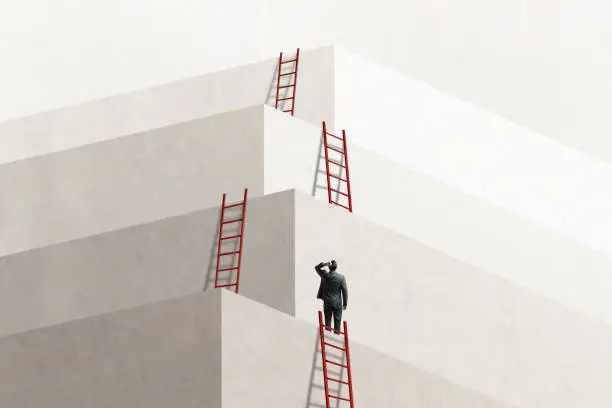 Photo of Man Looks Up At Series of Ladders Leading To Successively Higher Levels