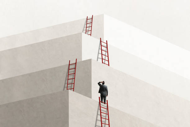 man looks up at series of ladders leading to successively higher levels - challenge imagens e fotografias de stock