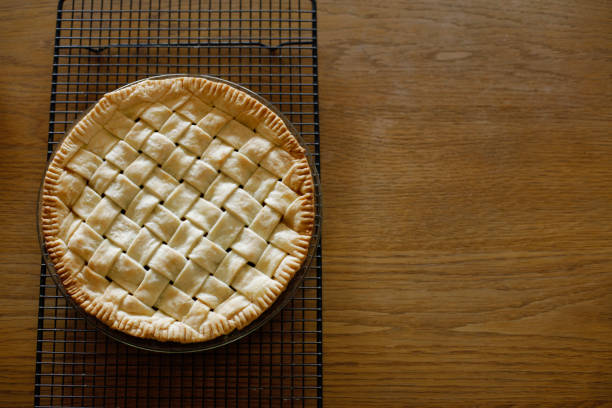 istock Top view of homemade apple pie on wire baking rack. Space for copy. 1387931408