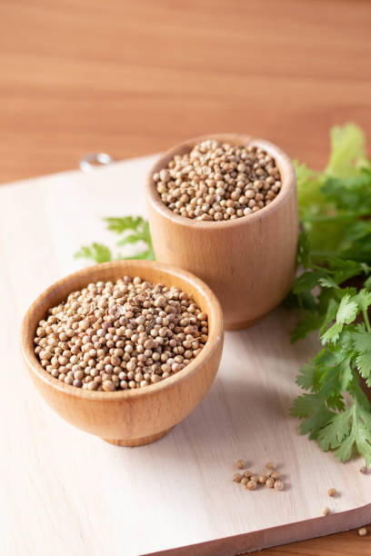 istock Coriander seeds in a wooden cup copy space 1387932342