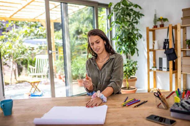 istock Creative young woman drawing at home 1387936023