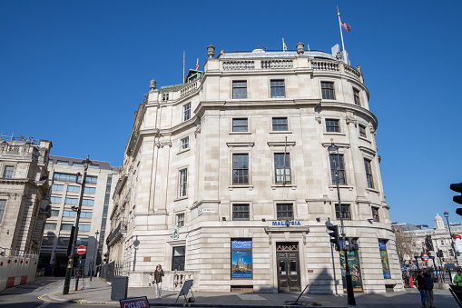 Uganda House at Trafalgar Square in City of Westminster, London, with people visible on the street.