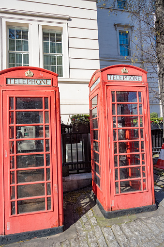 Red Telephone Boxes in Belgravia, London, with the royal seal visible.