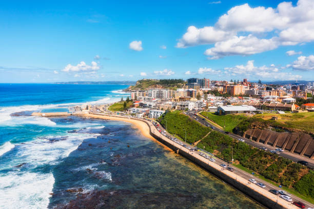 D Newcastle to pool CBD Aerial view of Newcastle city CBD from Pacific ocean over Newcastle beach and public rock pool. newcastle new south wales stock pictures, royalty-free photos & images