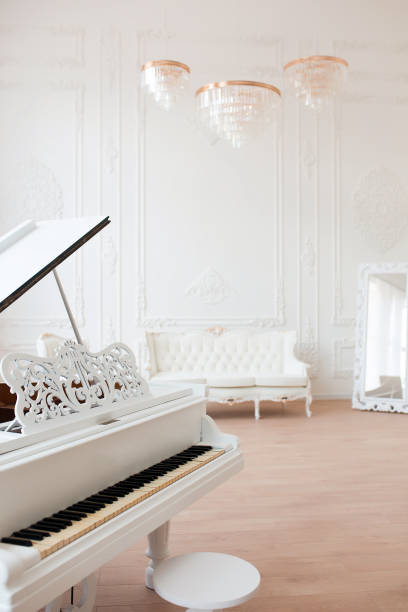 istock White grand piano standing in elegant classical interior 1387941632