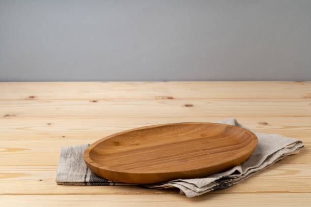 istock Cutting board with cotton napkin on wooden table 1387941819