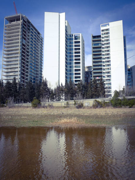 istock Modern multistory buildings reflected in water. Puddle with reflections. 1387941940