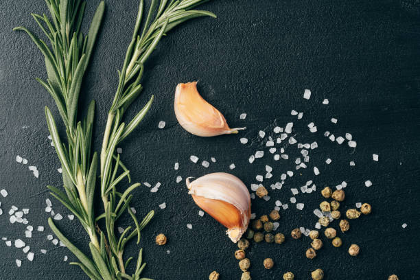 istock Salt and spices scattered on black background 1387942557