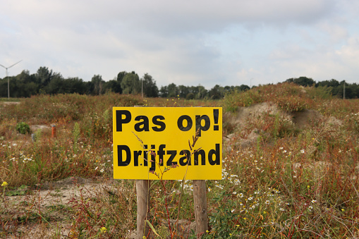 Sign for quicksand at fields where new residential district will arise in Waddinxveen