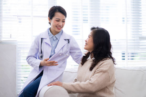 Asian female doctor examining an elderly woman at home Asian female doctor examining an elderly woman at home consulting doctor stock pictures, royalty-free photos & images