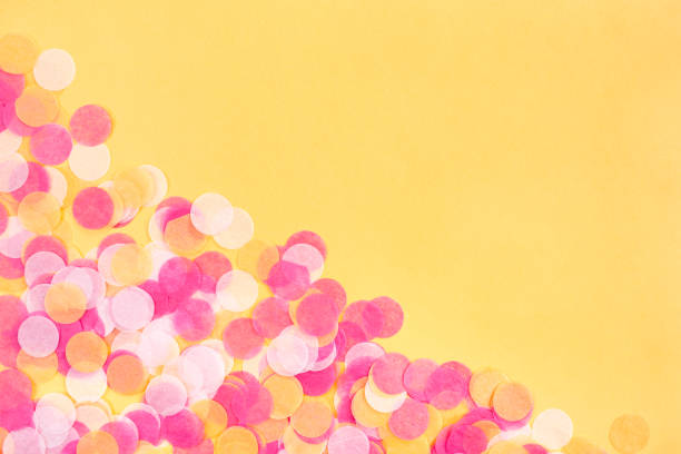 istock Orange, pink and white confetti on orange background. 1387949623