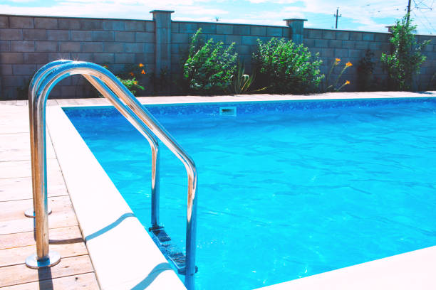 istock Swimming pool with stair at hotel. 1387949643