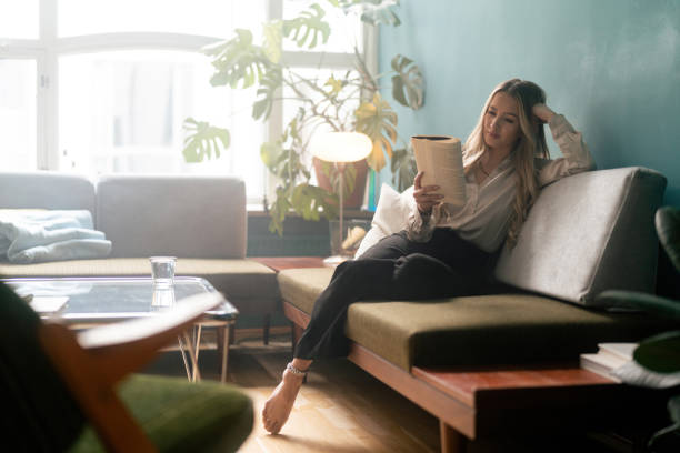 Woman reading a book on the sofa