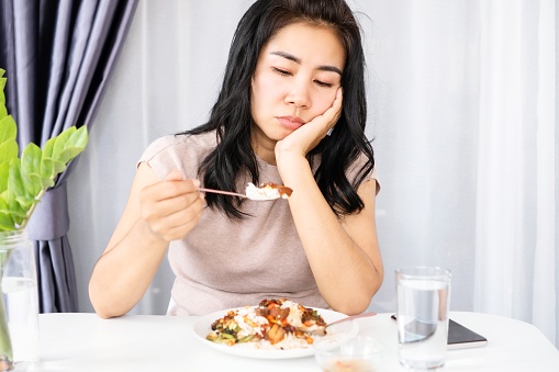 Asian woman lost appetite having problem with anorexia , bored with food