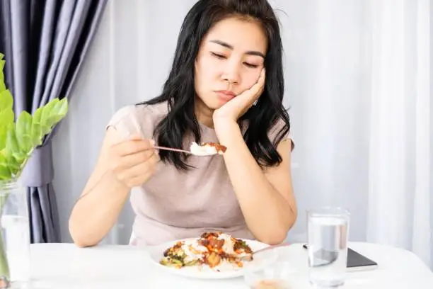 Photo of Asian woman having problem with anorexia ,bored with food, and lost appetite