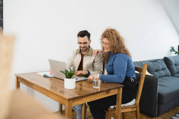 istock Husband and wife working together from their home office 1387955683