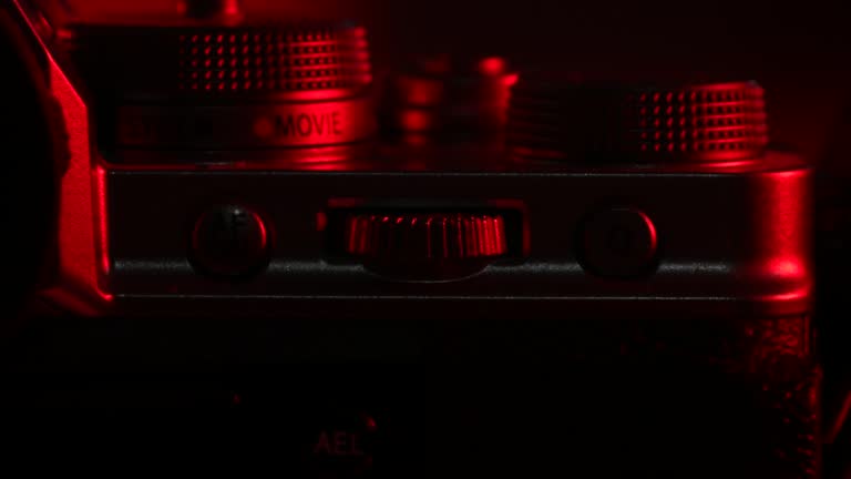 Macro shot of camera buttons, optical wheel. DSLR or mirrorless photography, videography device. Switching mode of still to movie.