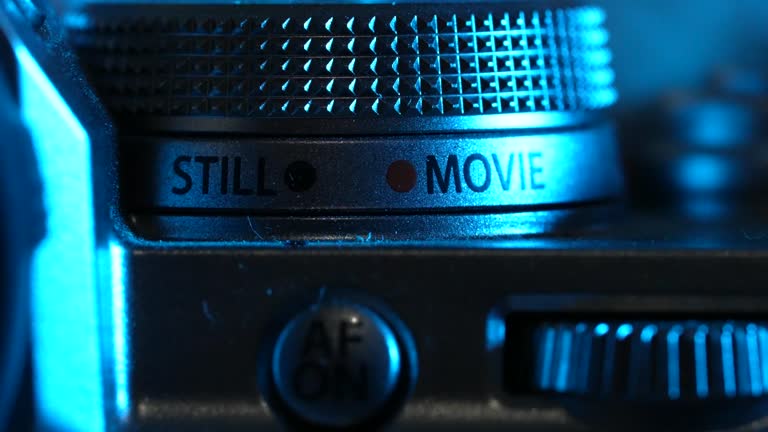 Macro shot of camera buttons, optical wheel. DSLR or mirrorless photography, videography device. Switching mode of still to movie.