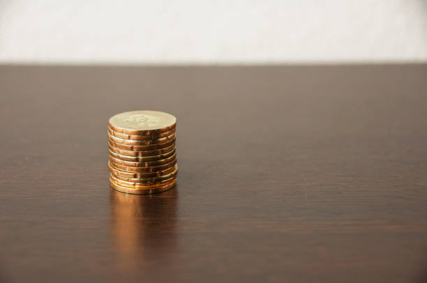Golden coins stack on wooden table - Copy space and growth Concept