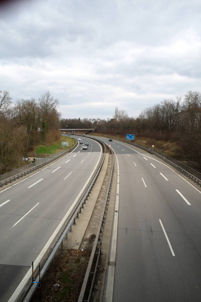 istock View of motorway, lined by trees, with few vehicles 1387958399