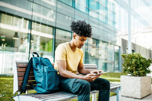 istock African American man with curly hair and braids using digital tablet 1387960334