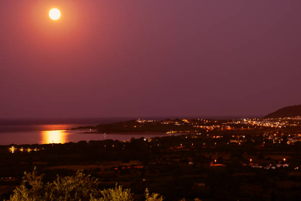 A landscape of Sardinian sea during a red moon