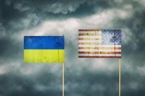 Bandera de Ucrania y América. Cielo nublado. Política. Economía. photo