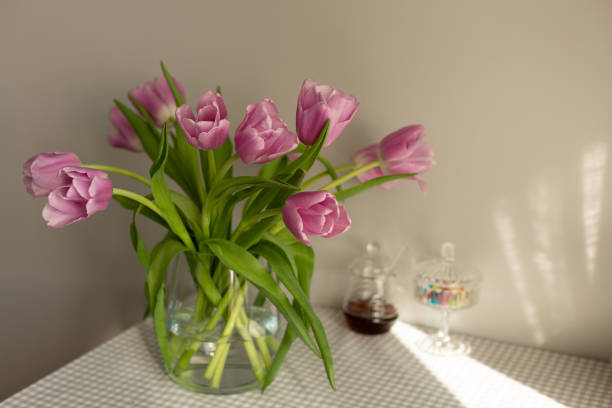 istock Lilac tulips in a vase on the kitchen table 1387965764