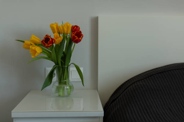 istock Yellow and red tulips on the bedside table 1387965769