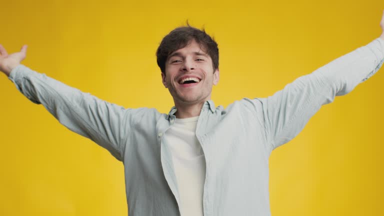 Wealth and success. Young excited man enjoying win and financial profit, making money rain, throwing banknotes into air