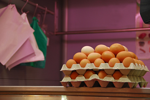 Madrid: market place: a heap of fresh chicken egg displayed on a counter.