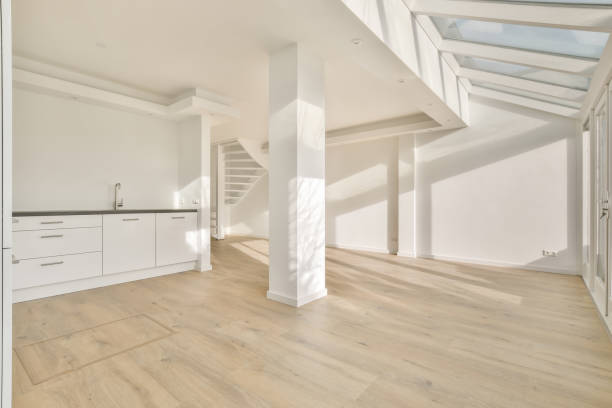 istock A large spacious room with a small kitchen and a staircase 1387967276