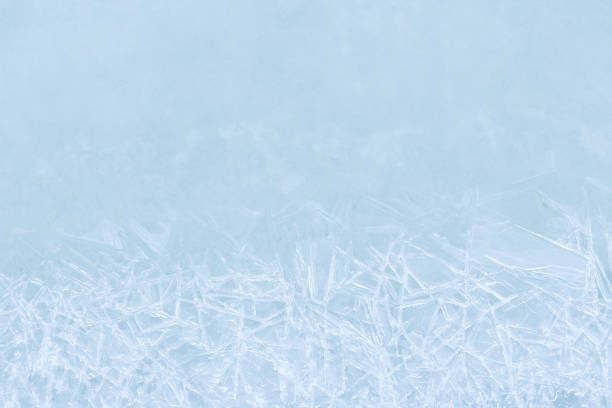 Ice pattern on the water surface winter, closeup. Natural ice  background. Texture frozen natural blue ice crystals, top view