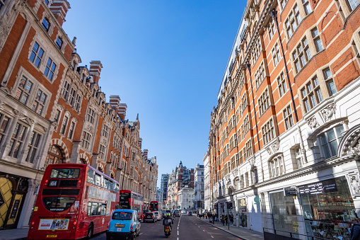 Traffic on a City Street in Knightsbridge, London, with Mandarin Oriental Hotel on the right.