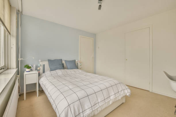 istock A bedroom with a bed with a checkered bedspread 1387971290