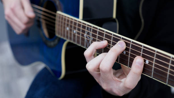istock man playing guitar chord in C major 1387972388