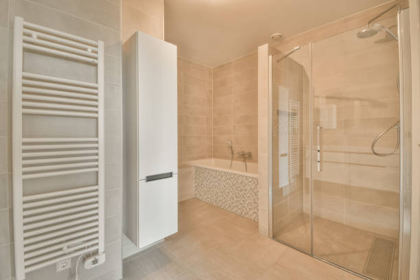 istock Spacious bathroom with beige tiles 1387973175